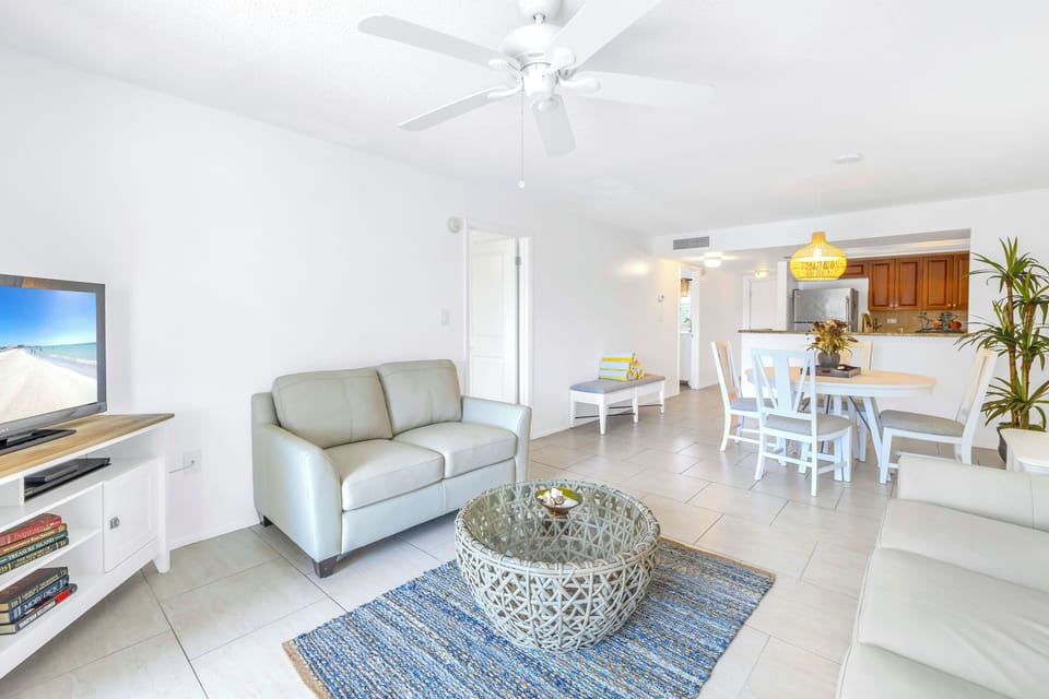 Living area with TV and ceiling fan.