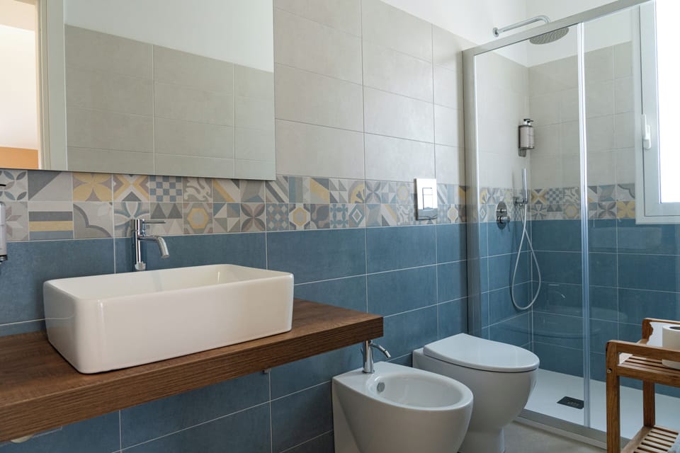 Deluxe Room, Balcony, Sea View | Bathroom | Shower, rainfall showerhead, slippers, bidet
