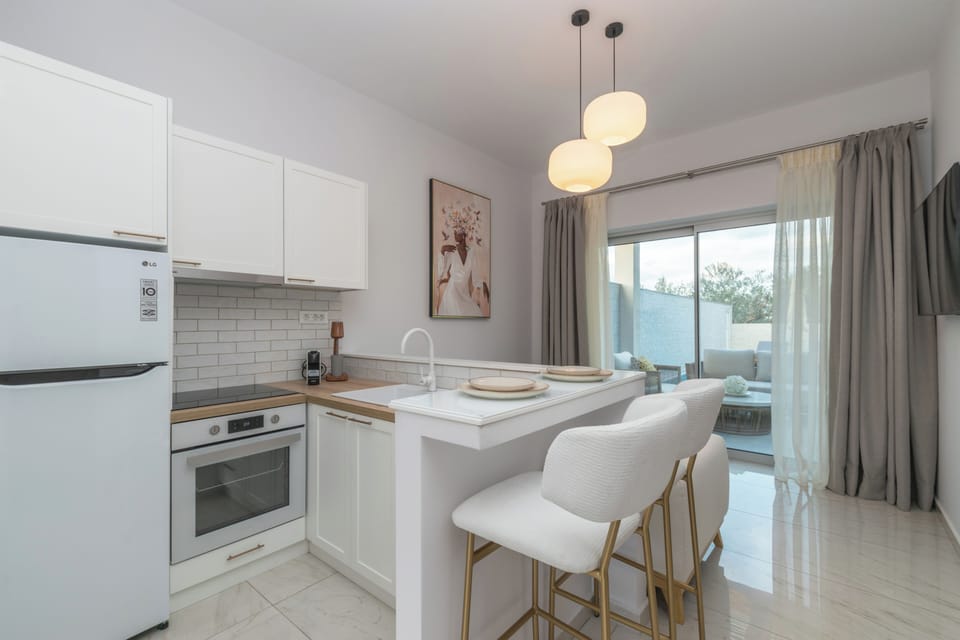 Luxury Suite, Pool View | Private kitchen | Full-size fridge, oven, stovetop, espresso maker