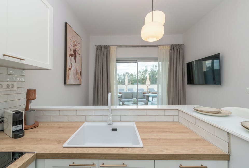 Luxury Suite, Pool View | Private kitchen | Full-size fridge, oven, stovetop, espresso maker