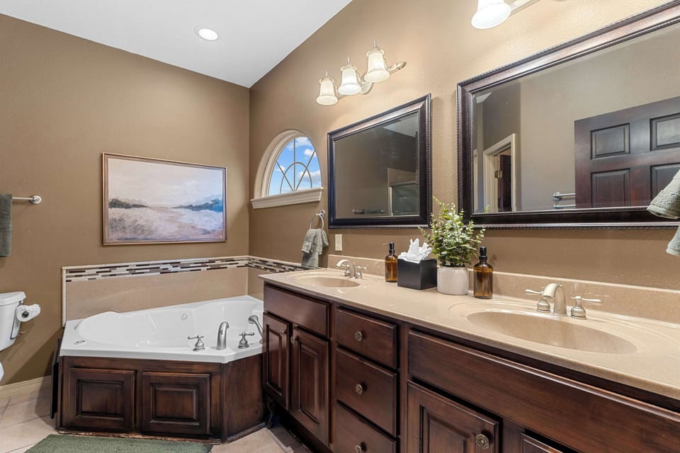 Bathroom 1 features double sinks and a spa tub!