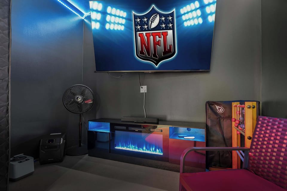 75” Smart TV + electric fireplace — the perfect setup for game day, movie night, or winding down in the Spa + Hangout Room.