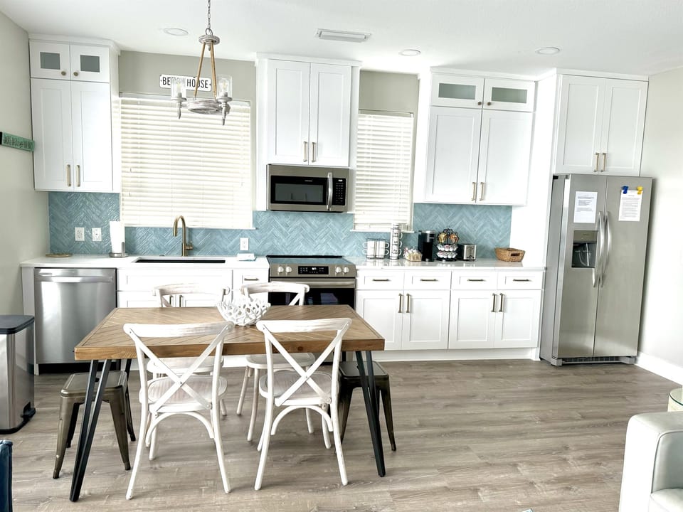 Upstairs kitchen with coffee bar and seating for 6 guests.