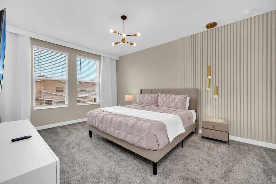 Enjoy a little extra relaxation in this spacious king bedroom featuring comfortable bedding, tasteful décor, a flat-screen TV, and high-speed Wi-Fi—your own peaceful retreat during your vacation.