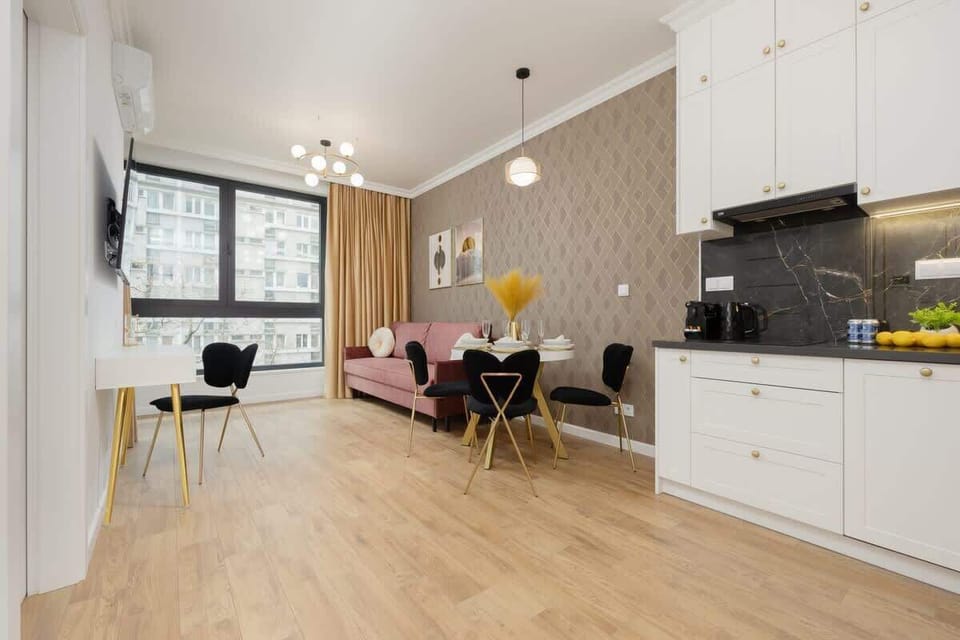 A full view of the open-plan living, dining, and kitchen space, showcasing its elegant and practical layout.

