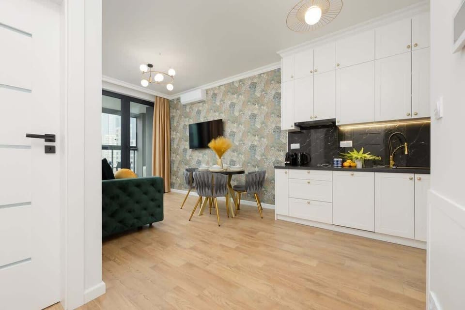 Another angle of the kitchen and dining area, showing the open-plan layout and the seamless connection between spaces.

