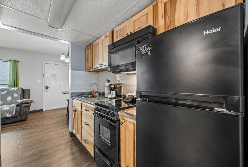 The kitchen is fully stocked with silverware, dishware, cookware and appliances.
