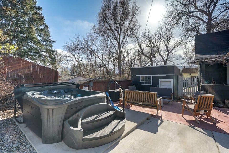 Sink into the hot tub on the patio, then dry off in the nearby lounge chairs while bare trees frame the open sky—an easy, quiet reset after a full day.