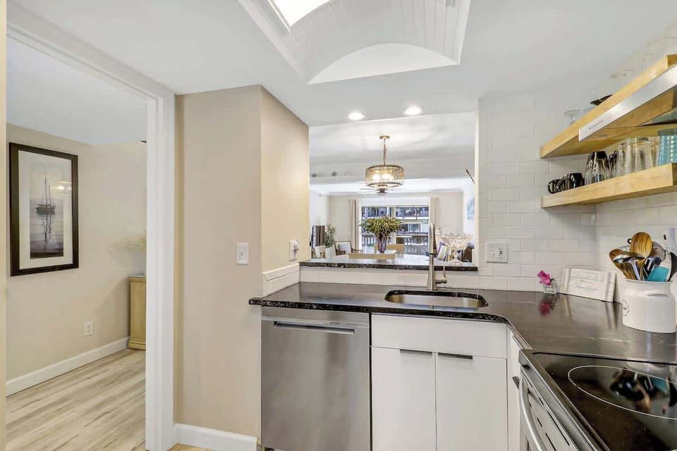 Your sleek kitchen features granite countertops, stainless steel appliances, and open shelving for effortless cooking adventures.