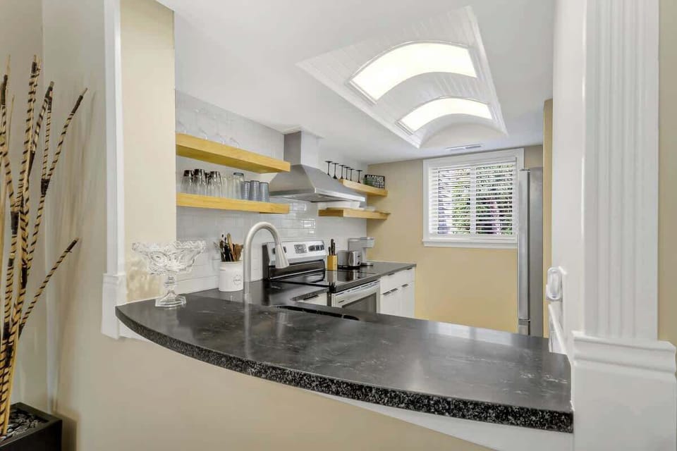 Your gourmet kitchen features sleek granite countertops, modern appliances, and gorgeous skylights that bathe your cooking space in natural light.