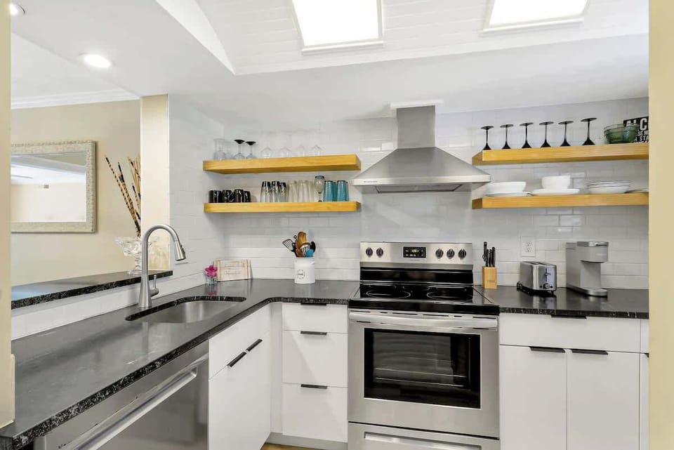 Your gourmet kitchen features sparkling countertops, modern appliances, and open shelving filled with everything you need for memorable meals.