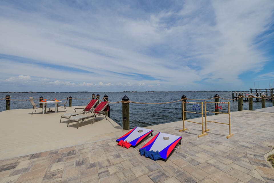 - Challenge your crew to a game of cornhole right by the water’s edge
- Relax in lounge chairs or enjoy lunch at the bistro table with a view
- Waterfront fun and comfort blend perfectly on this oversized dock area