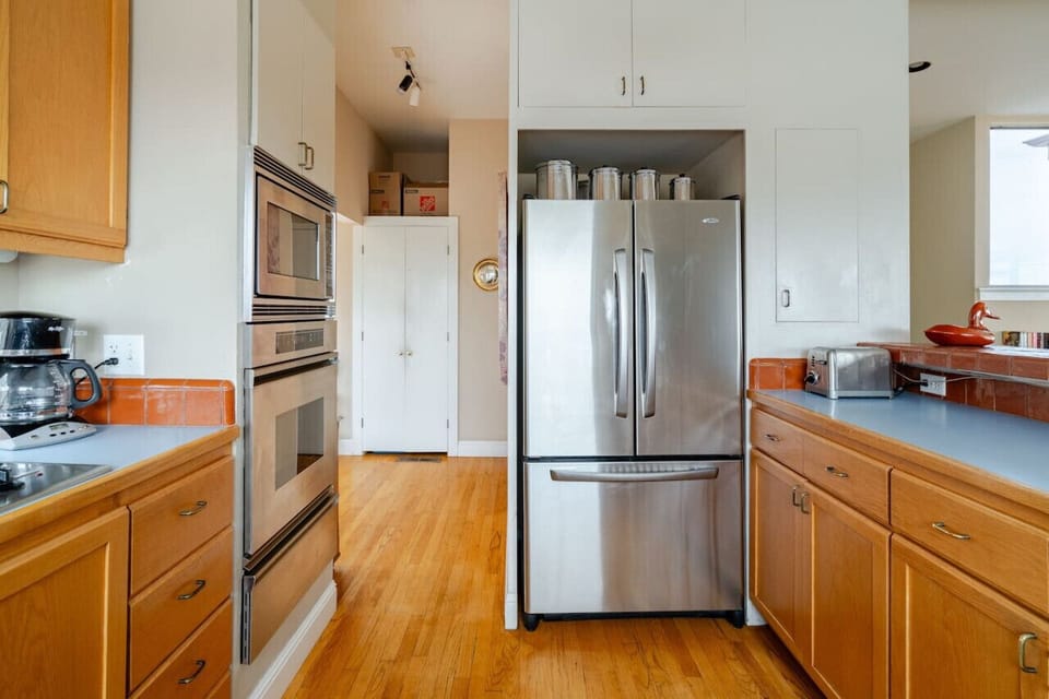 Our  kitchen offers a two-door refrigerator, oven, microwave, and stove, ensuring you have everything you need for effortless cooking