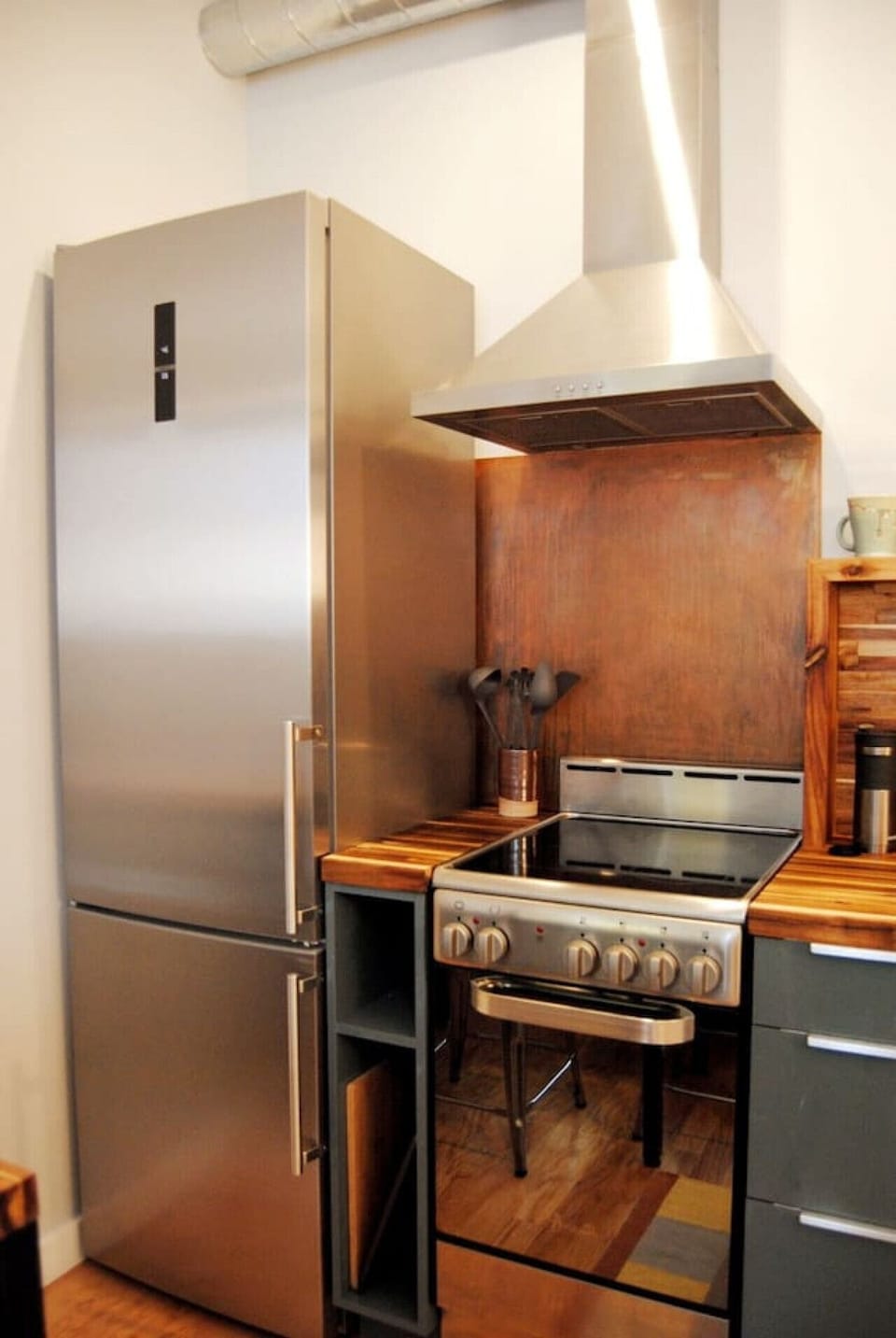 Contemporary Kitchen Featuring Sleek Metals and Natural Wood