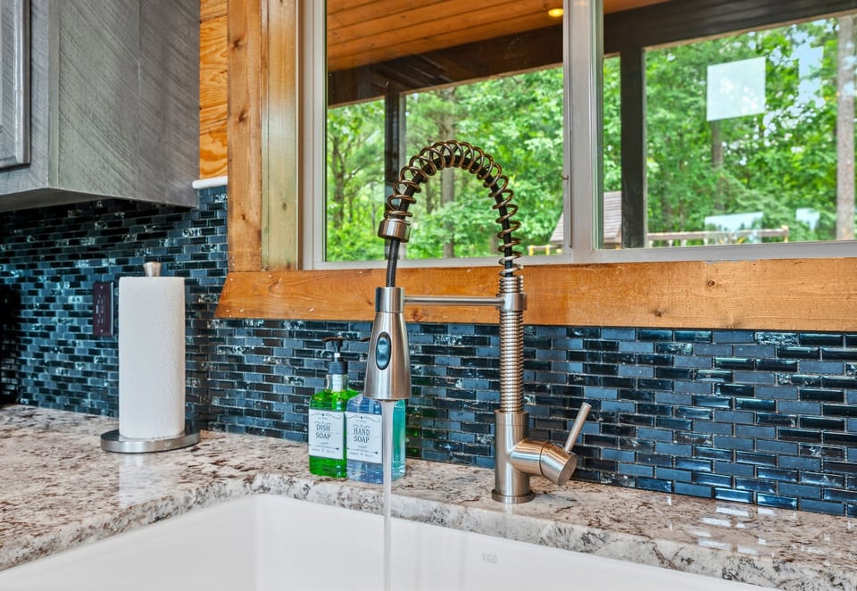 Doing dishes doesn’t get better than this — gaze out at the trees while the forest keeps you company.