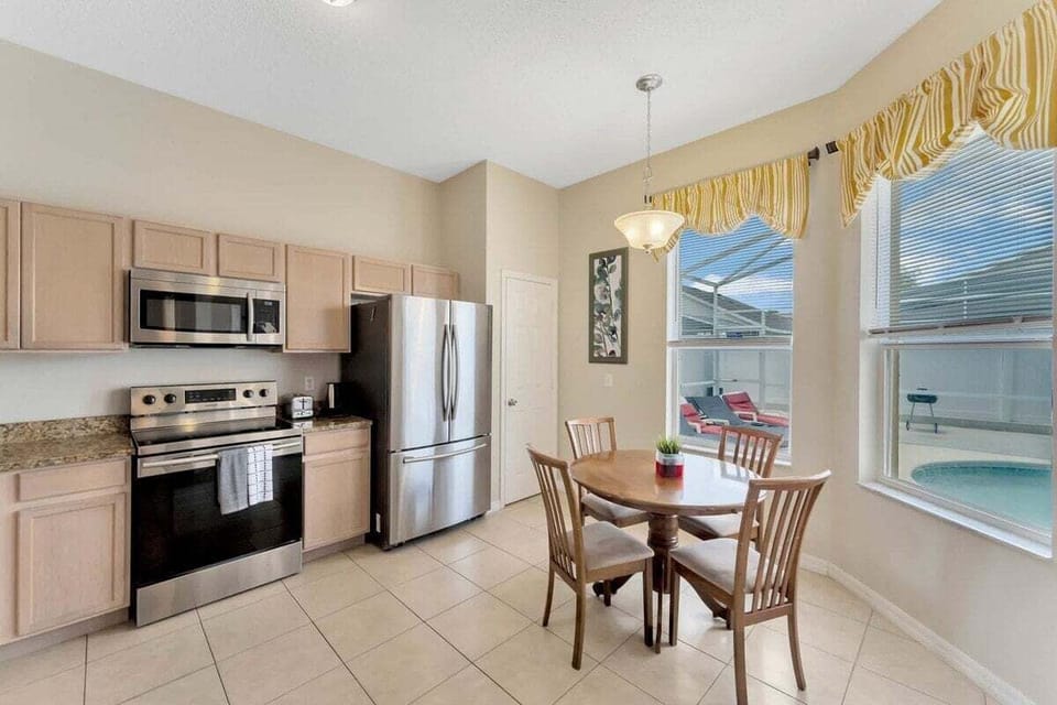 Enjoy easy meals with a full kitchen and dining area overlooking the pool