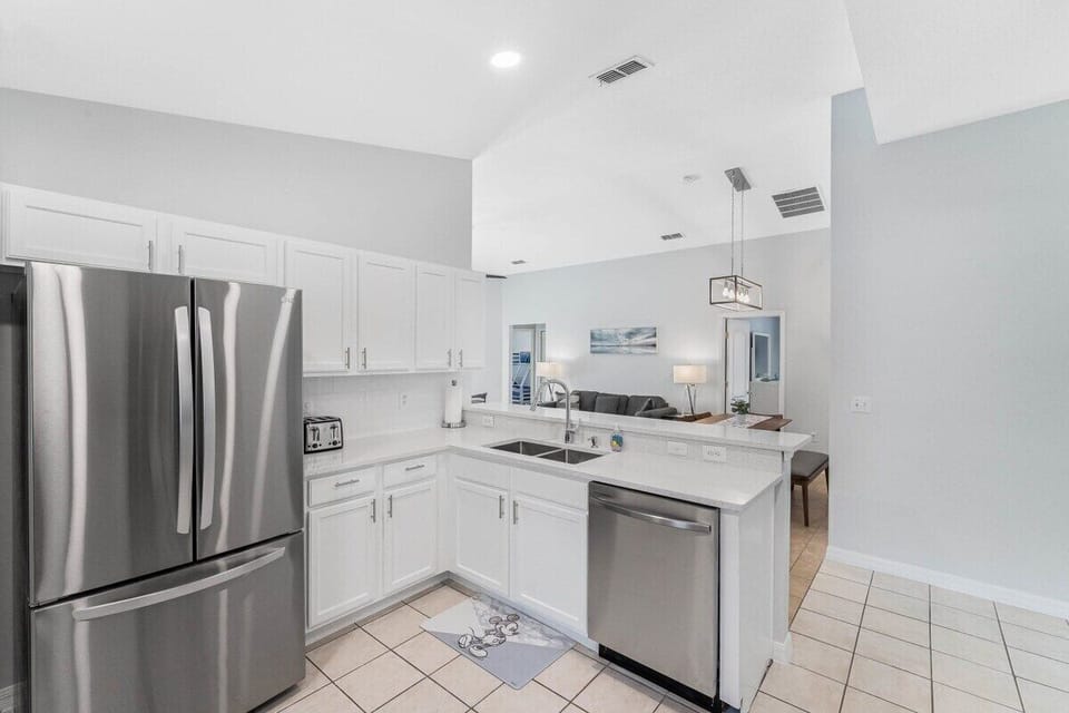 Cook with ease in this bright, open-concept kitchen featuring stainless steel appliances, a breakfast bar, and everything you need for a home-cooked meal.
