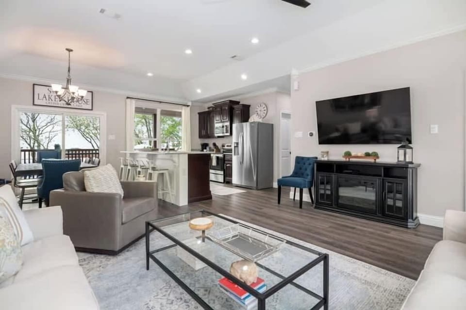 Large mounted Smart TV and electric fireplace.