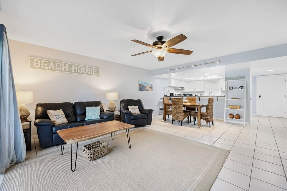 Open-concept living and dining area with coastal decor and comfortable seating.