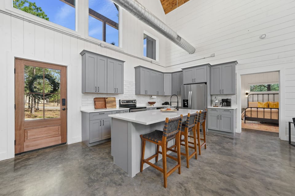 The kitchen island provides additional barstool seating.