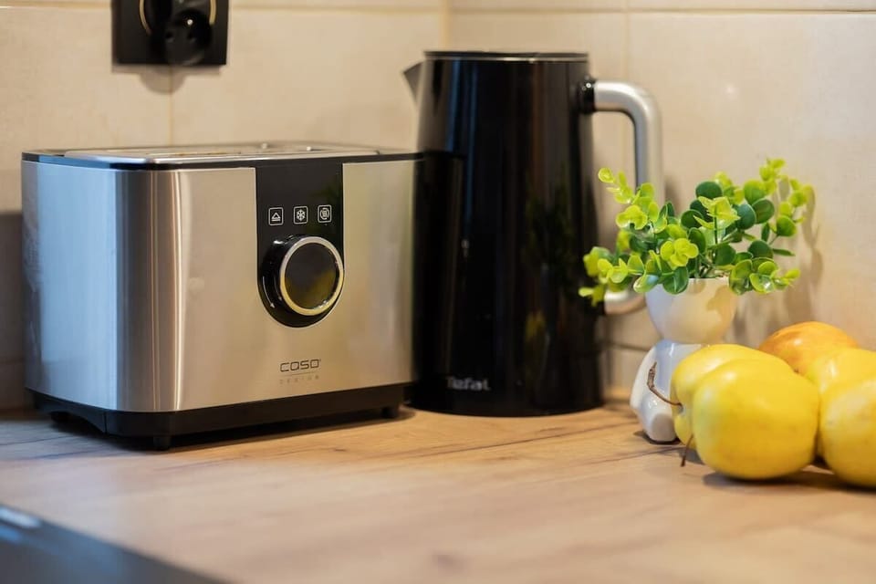 Modern kitchen worktop with toaster and electric kettle, fresh lemons, giving it a vibrant feel.