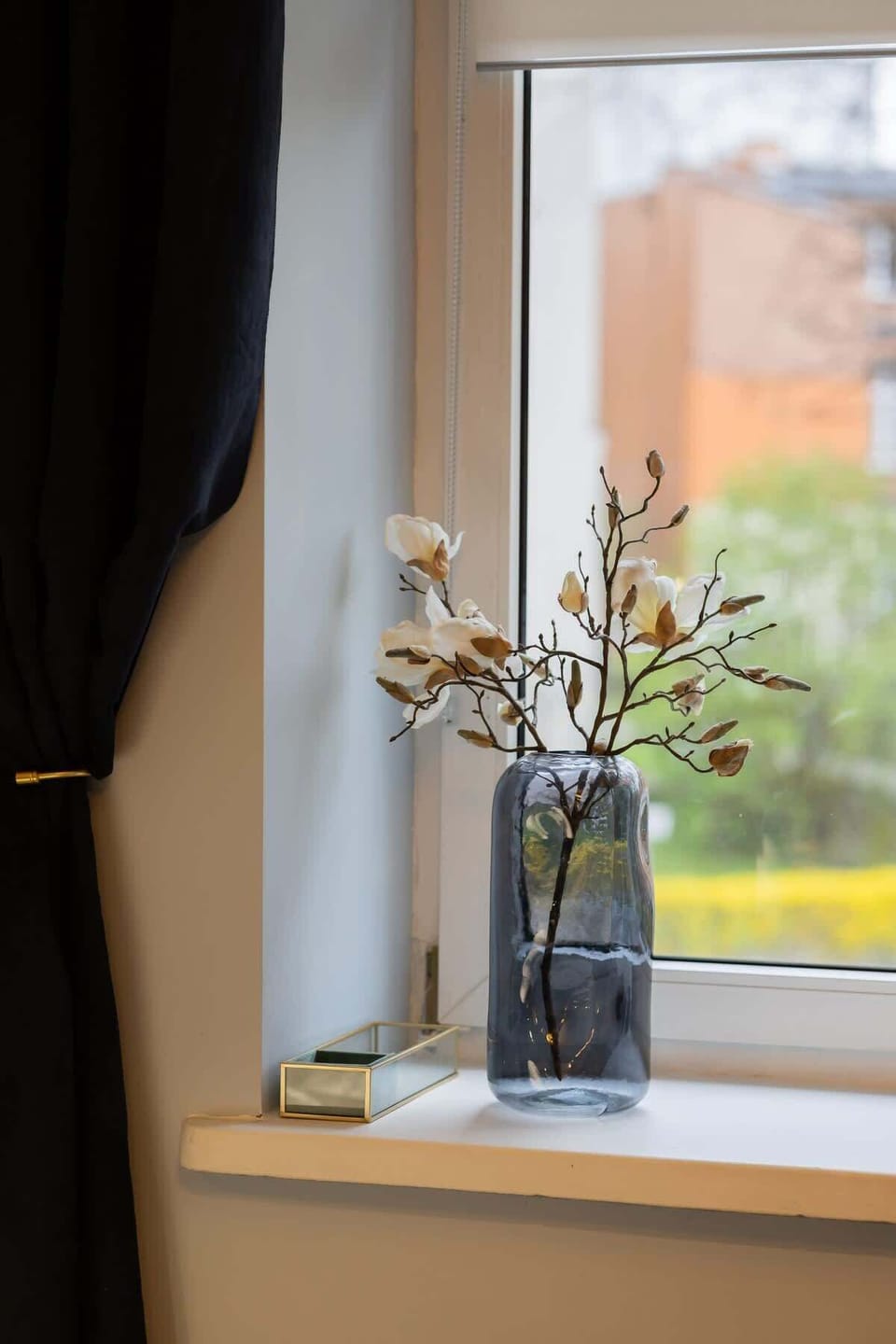 A close-up of a decorative vase filled with dried flowers, adding a rustic charm to the room.