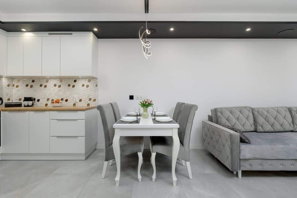 Cozy dining table setup for two with a vase of tulips.