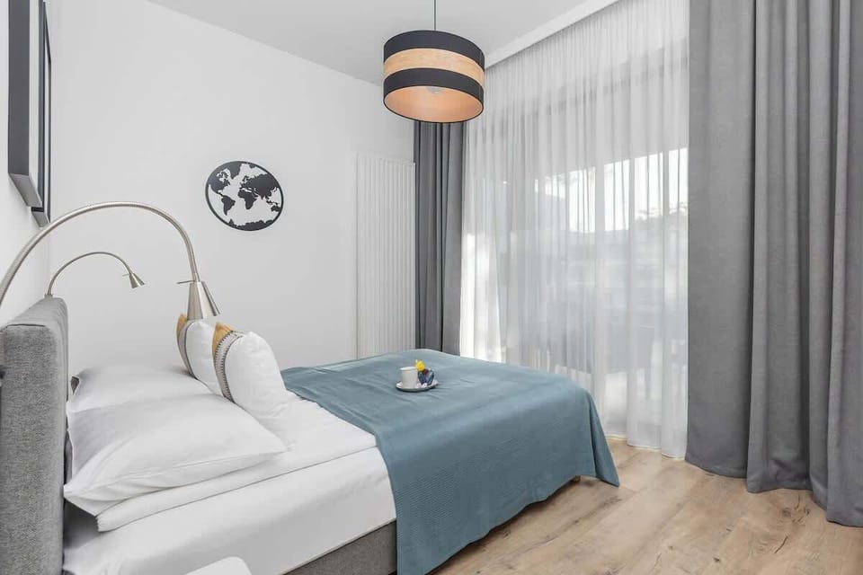 Comfortable bedroom with a bed, two bedside tables, and soft lighting.