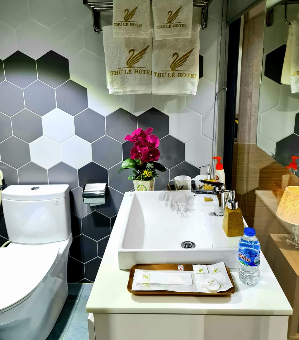 Deluxe Single Room | Bathroom | Rainfall showerhead, designer toiletries, hair dryer, slippers
