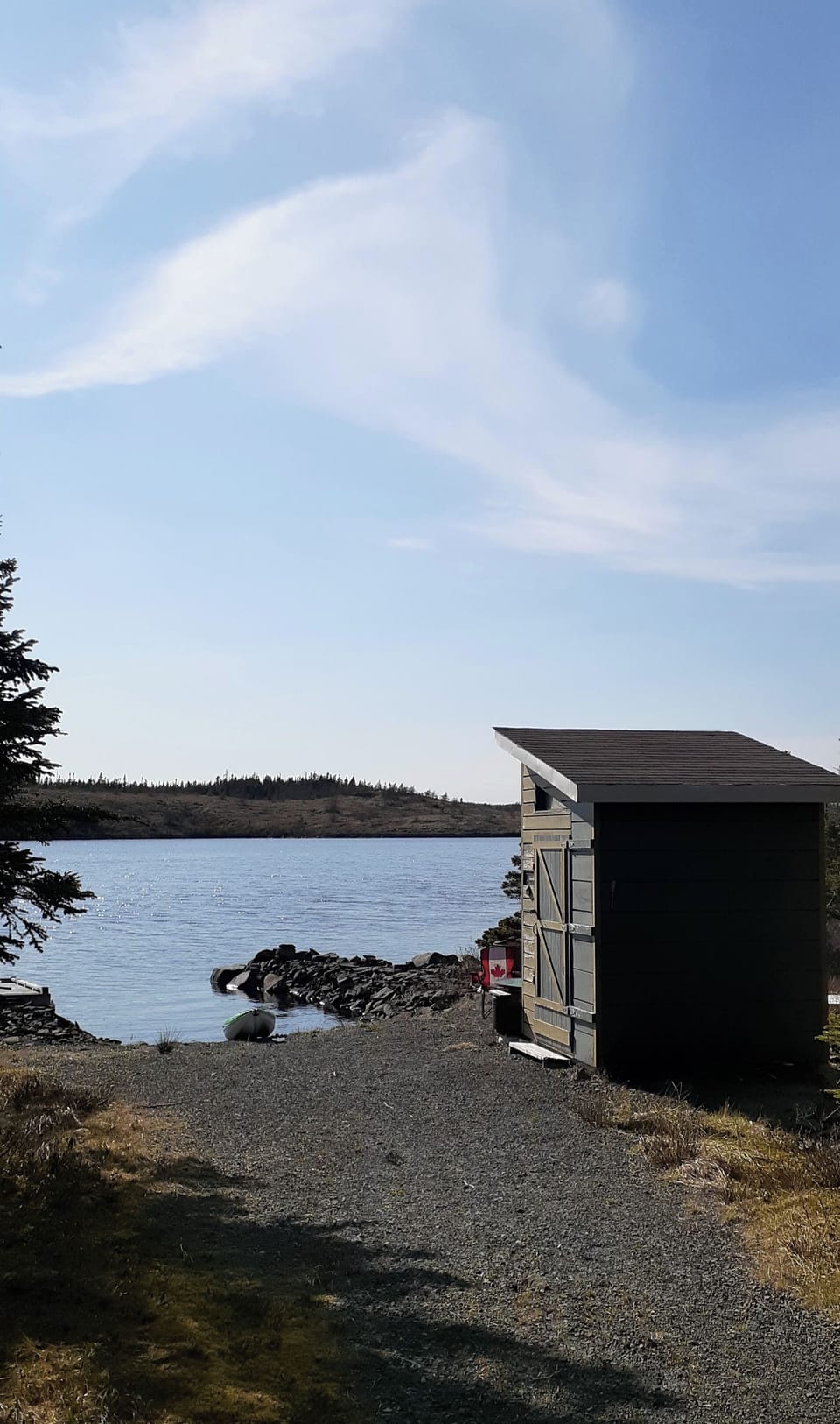 The lake shore and shed for chairs, paddles, life jackets and kayak
