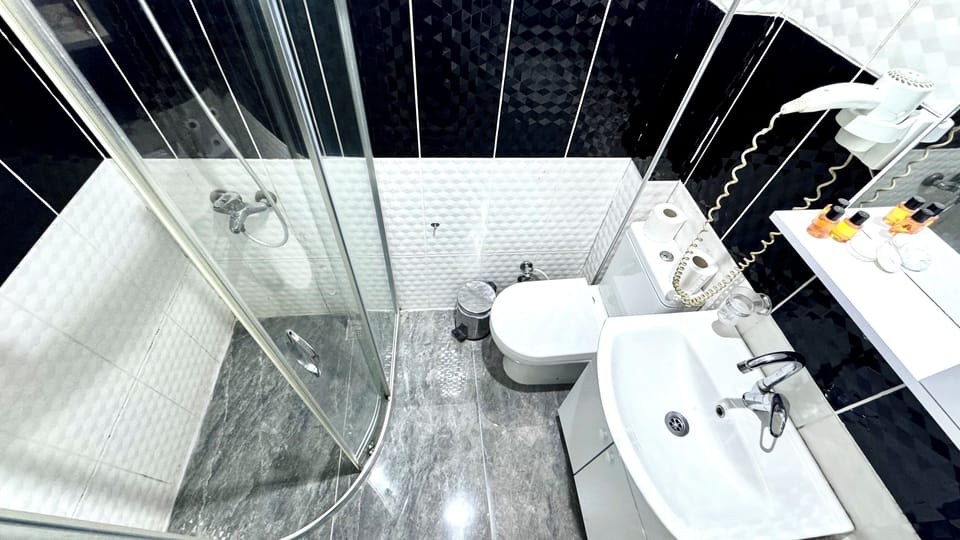 Shower, hair dryer, slippers, towels
