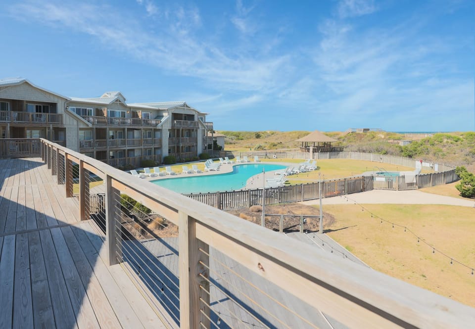 Step out onto the outdoors overlooking the pool — a good spot for your morning coffee