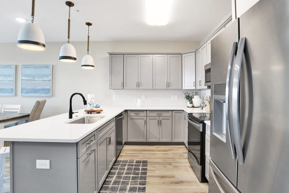 Modern kitchen meets coastal charm, with sleek appliances and a view that invites the calm of the ocean into your culinary adventures