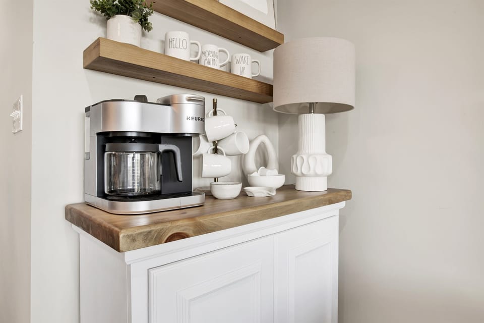 Begin your day with elegance and a perfect cup of coffee in this chic, warmly accented corner of the home.