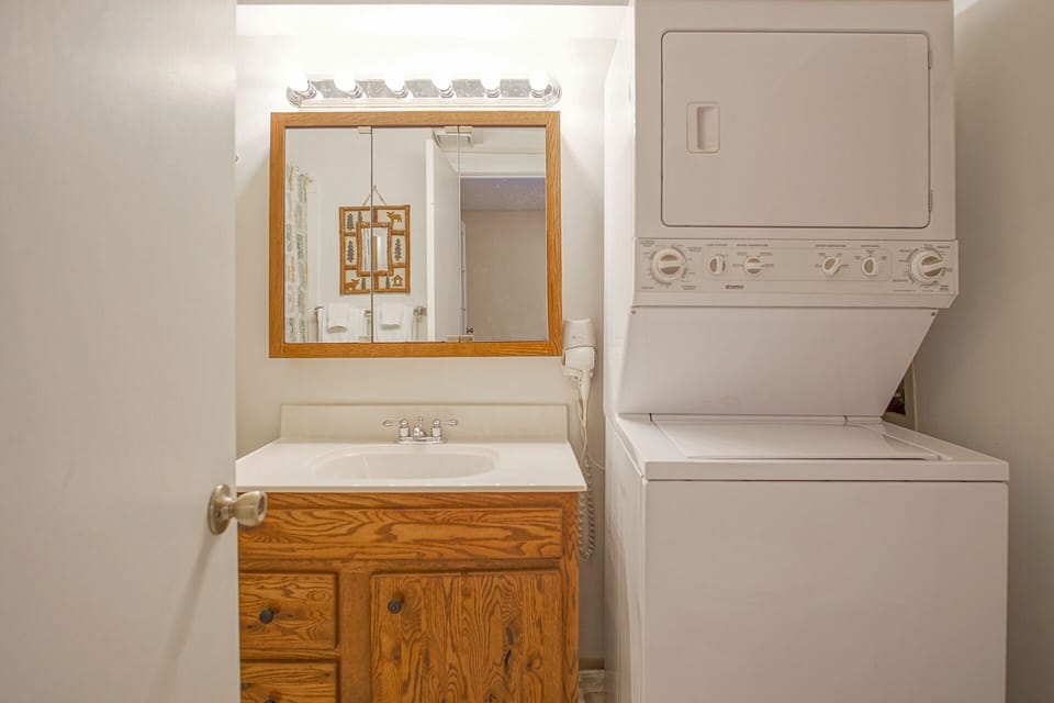 Full bathroom with a stackable washer/dryer