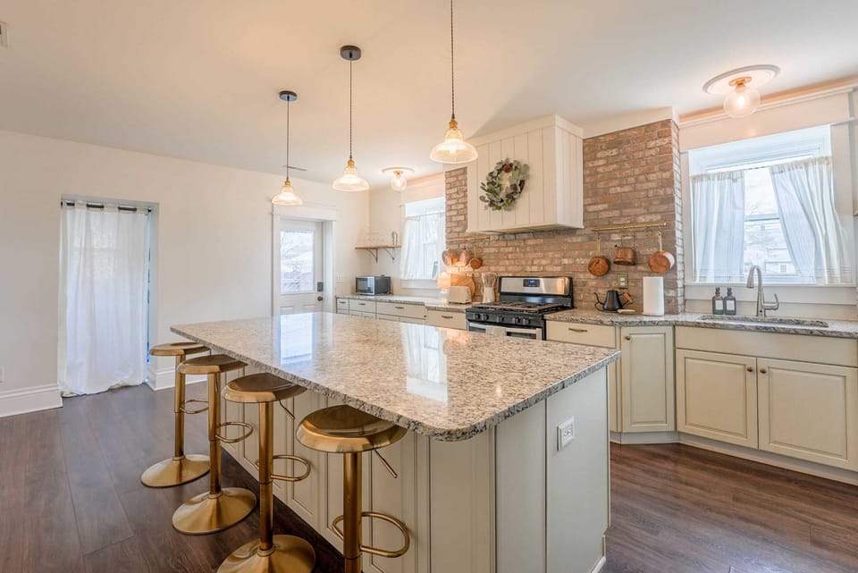 Cook up a feast in the fully stocked kitchen with granite island, stainless appliances & bar seating—made for foodies & entertaining.