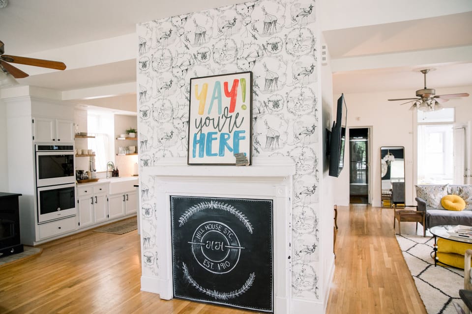 Entry with chalkboard – Welcoming central hearth with chalkboard art and playful “YAY you’re here” sign sets the tone for a memorable stay 🔥✨