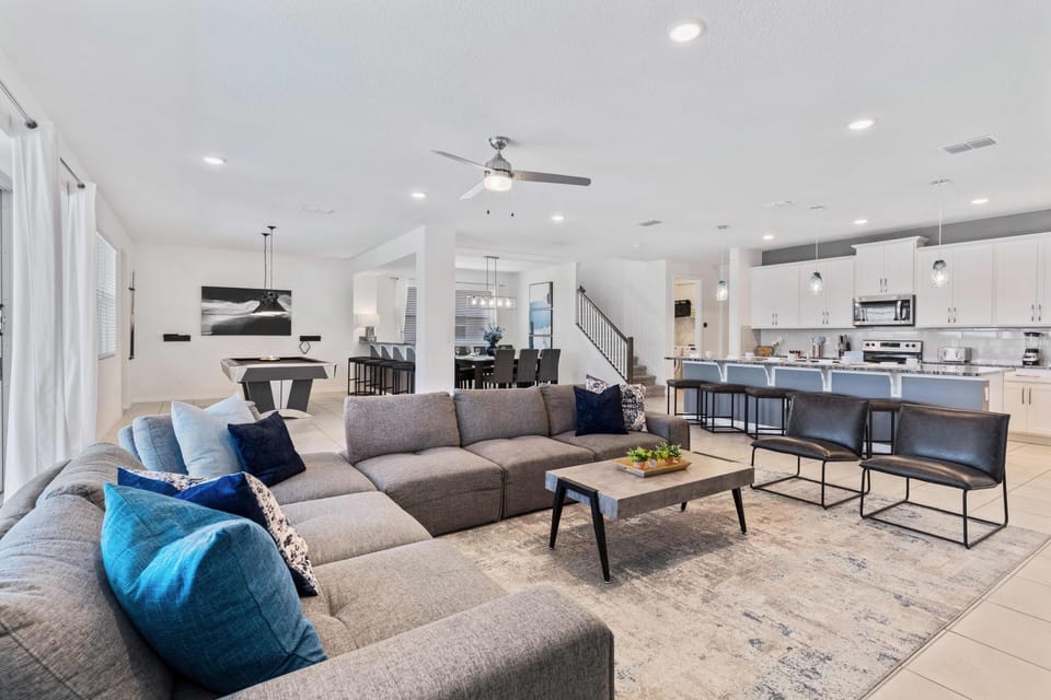 Lavish Living area of the home in Kissimmee - Comfy Sofas for sitting - Pool facing living area with thoughtfully located large bright windows - Beautifully furnished floor - Availability of TV and Netflix