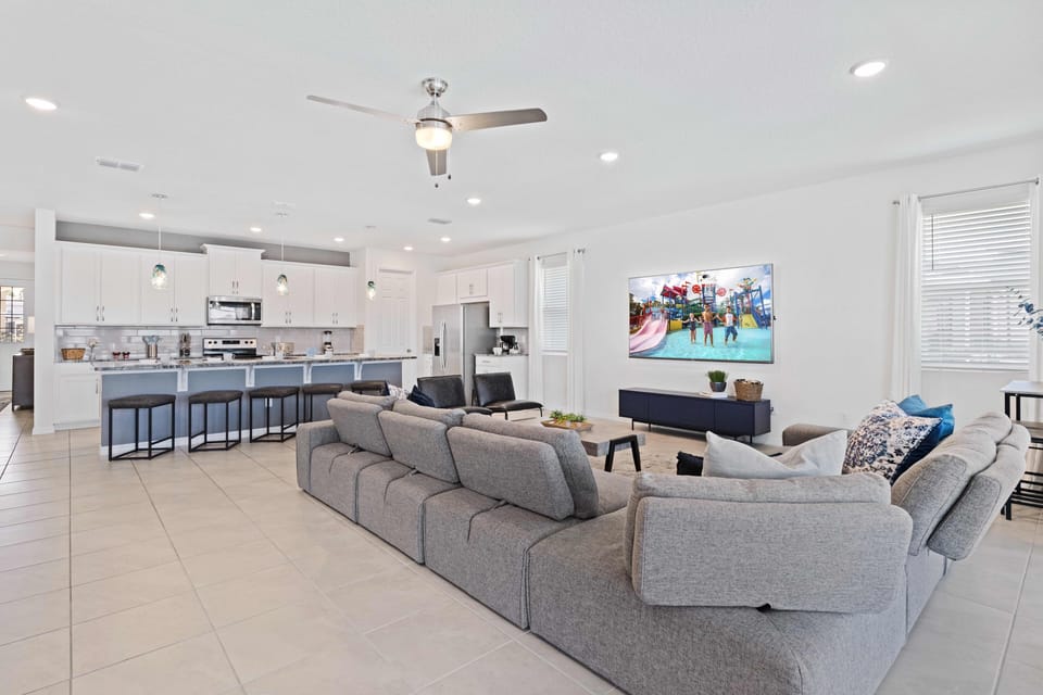 Magnificent living area of the home in Kissimmee - Comfy sofas to sit and relax - Majestic ambiance - Well-Designed open kitchen - Availability of TV and Netflix - Large windows with beautiful Pool views