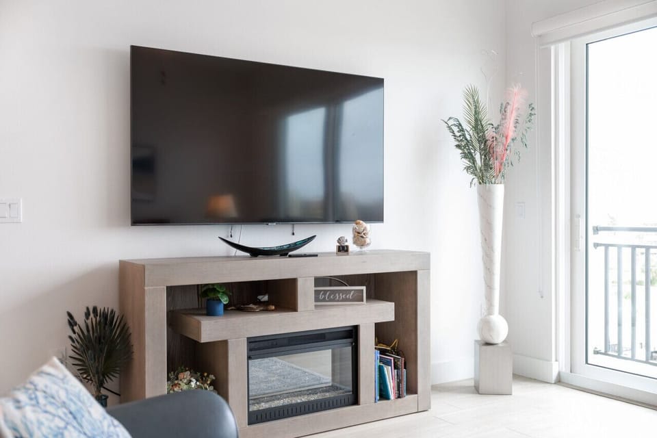 Media console w/ TV and clean lines, creating a simple spot for movie nights.