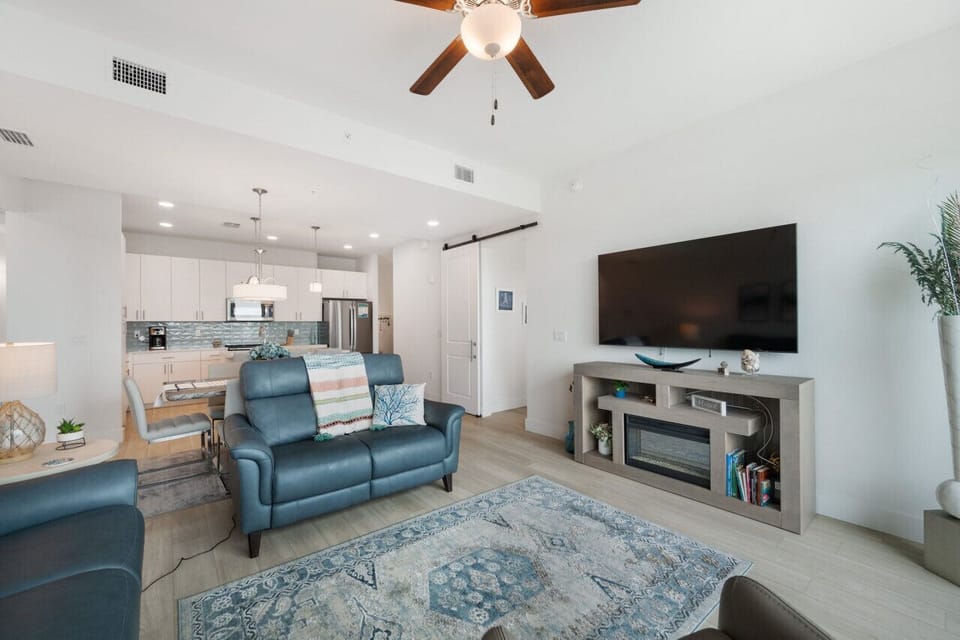 Open living area w/ comfy sofas, TV & seamless flow into the kitchen.