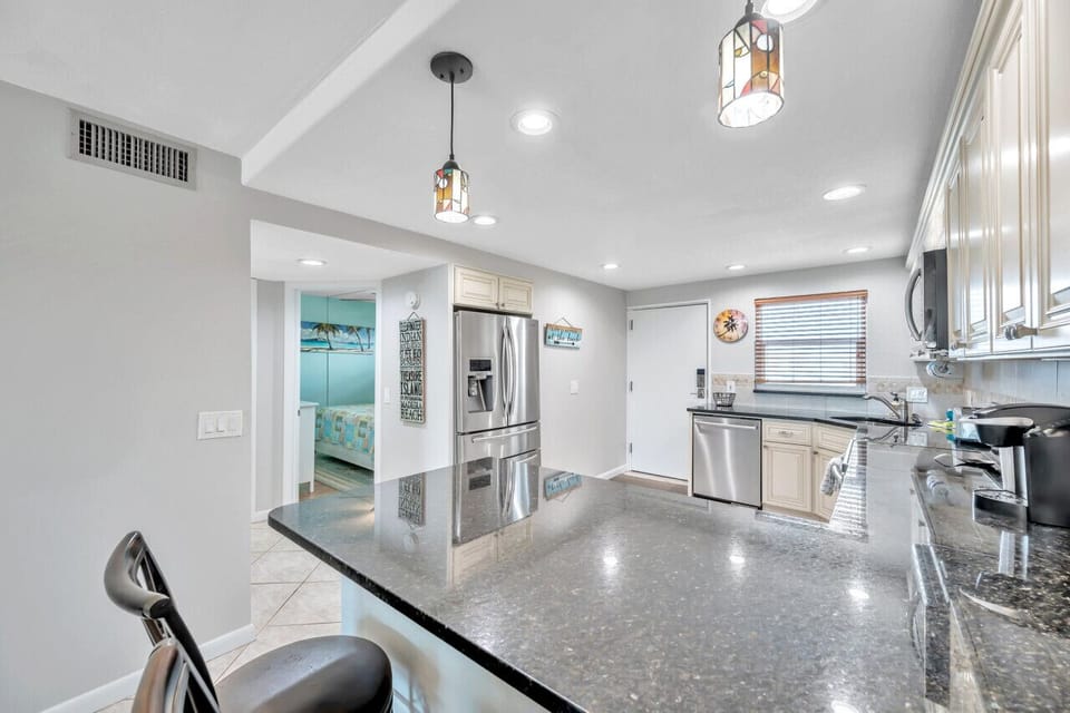 Bright open kitchen w/ bar seating and a seamless flow into the main living space.