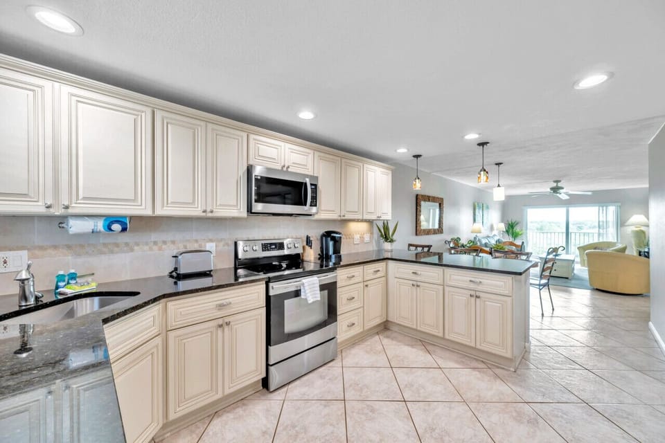 Spacious kitchen w/ ample counter space and modern appliances for easy meals at home.