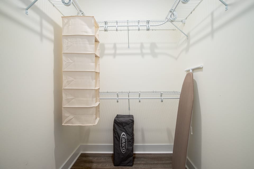 Walking closet where you will find Pack 'n Play and iron board