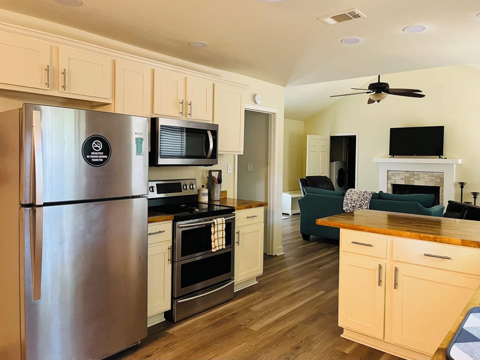 Large open layout kitchen with full size refrigerator and double ovens.