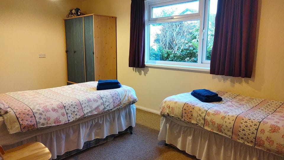 Twin single beds, wardrobe and wooden chair
