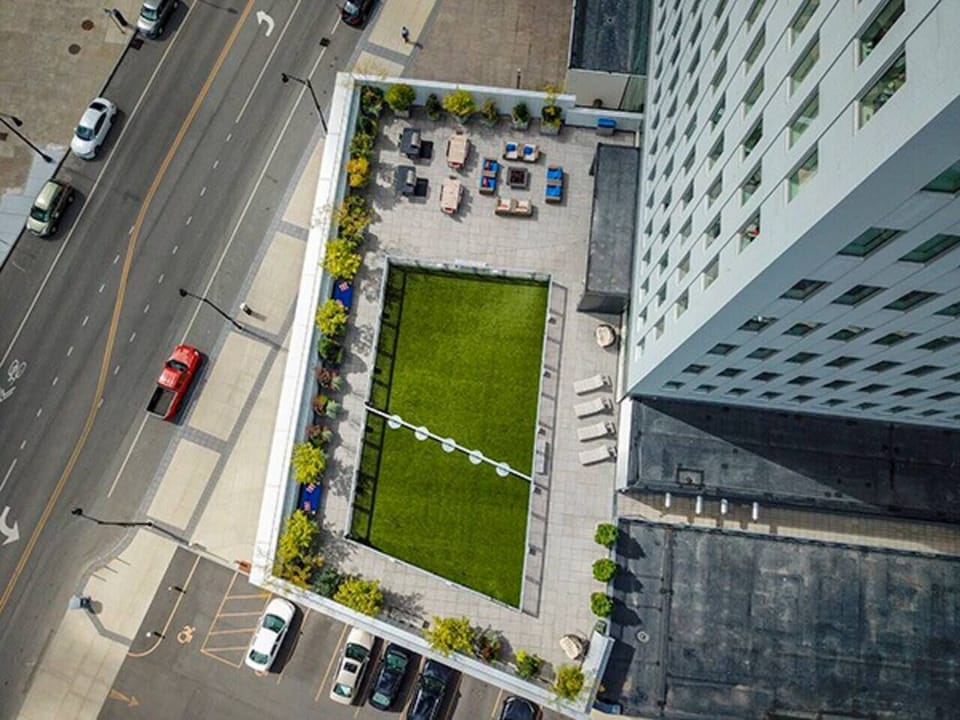 Looking Down from Apartment Unit onto Outdoor Building Terrace