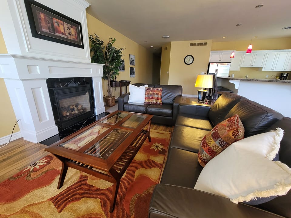 Signature Suite, 2 Bedrooms, 2 Bathrooms | Living area | 65-inch Smart TV with cable channels, fireplace