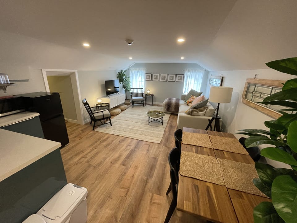 living room, kitchenette, and emergency exit hallway
