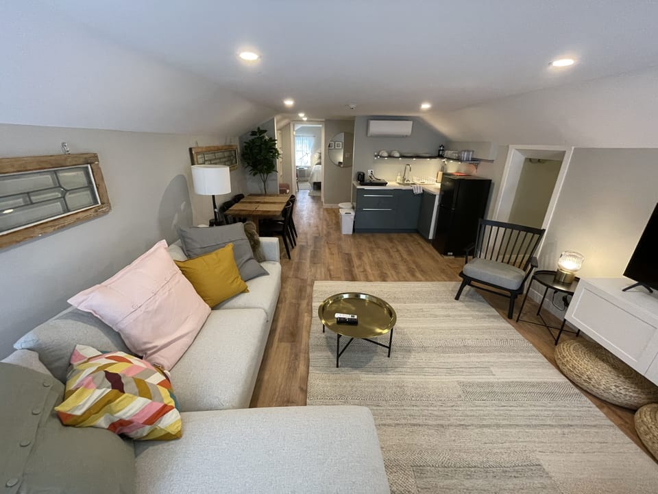 living room, kitchenette, and emergency exit hallway